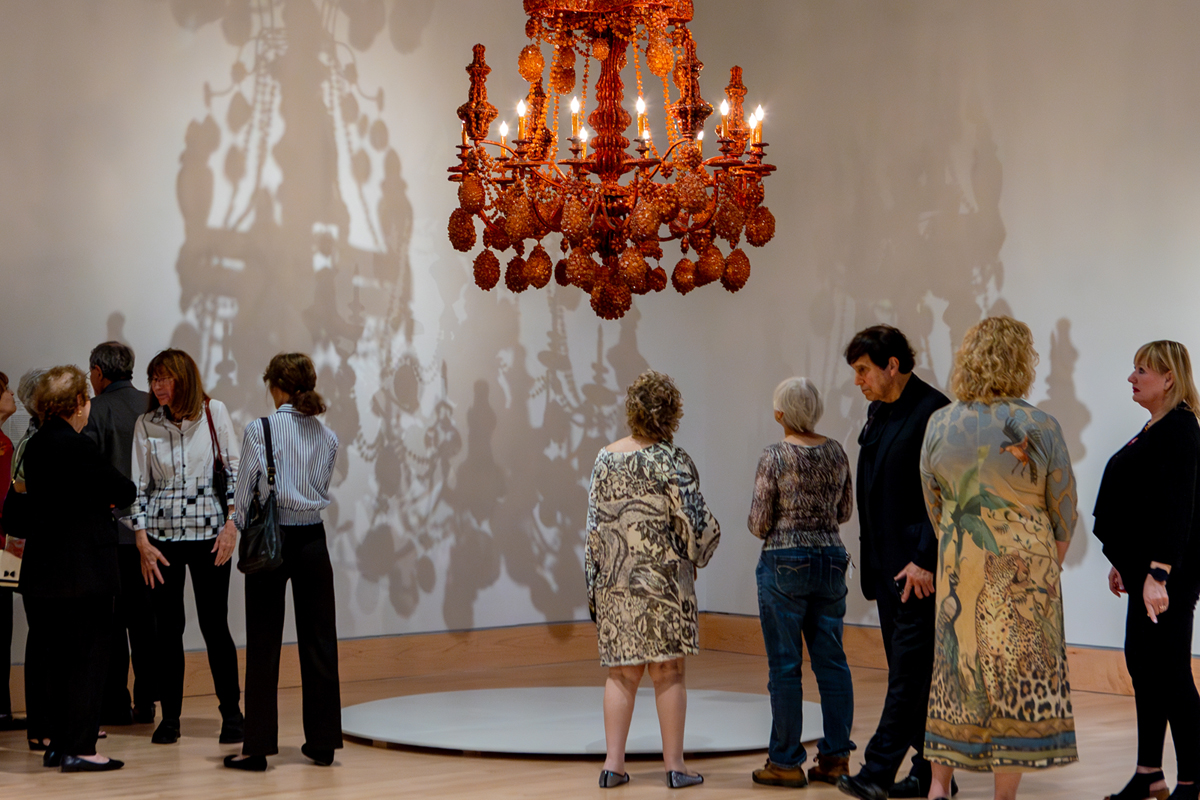 image of patrons viewing art in the gallery , 