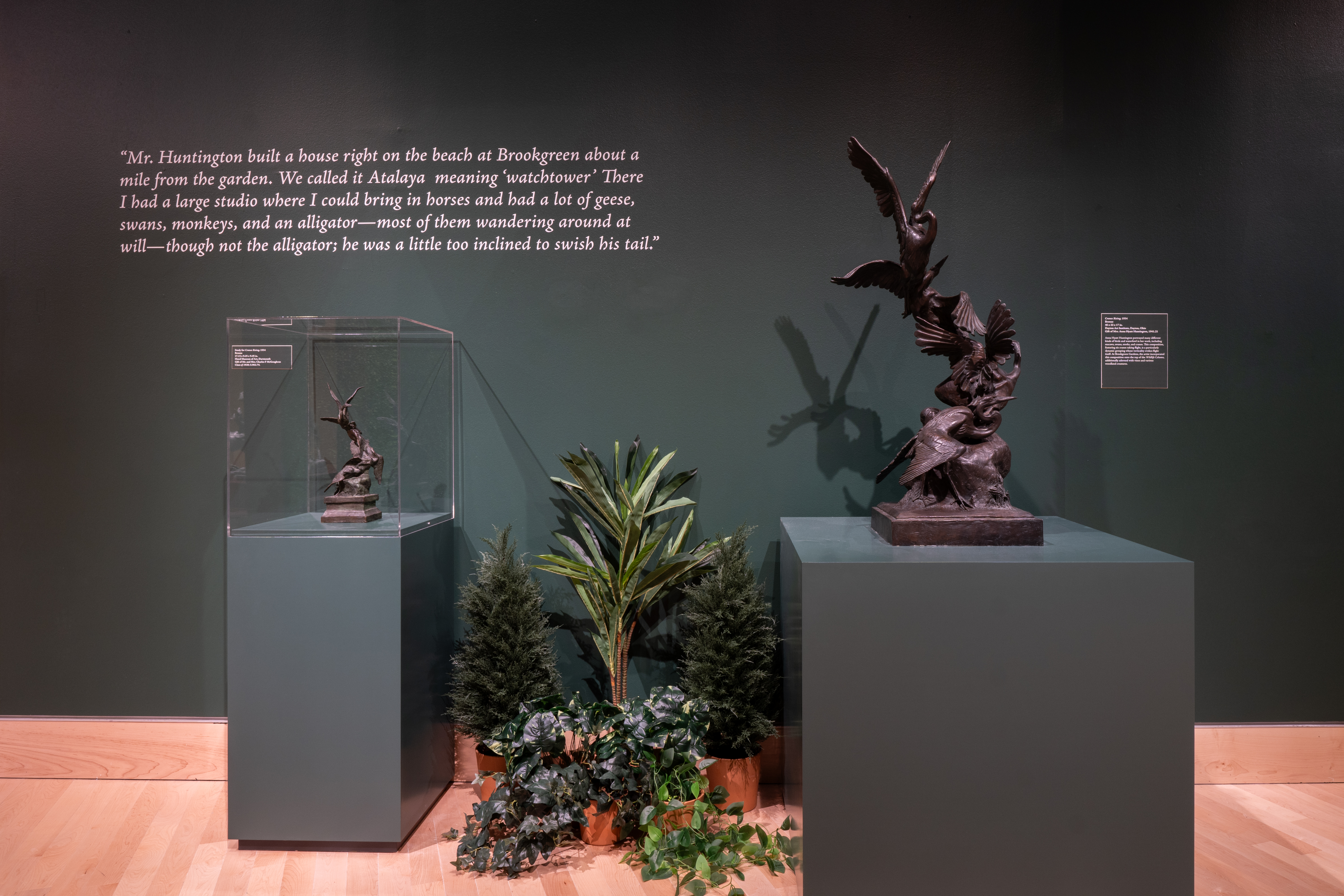 A winged creature sculpture and a miniature version