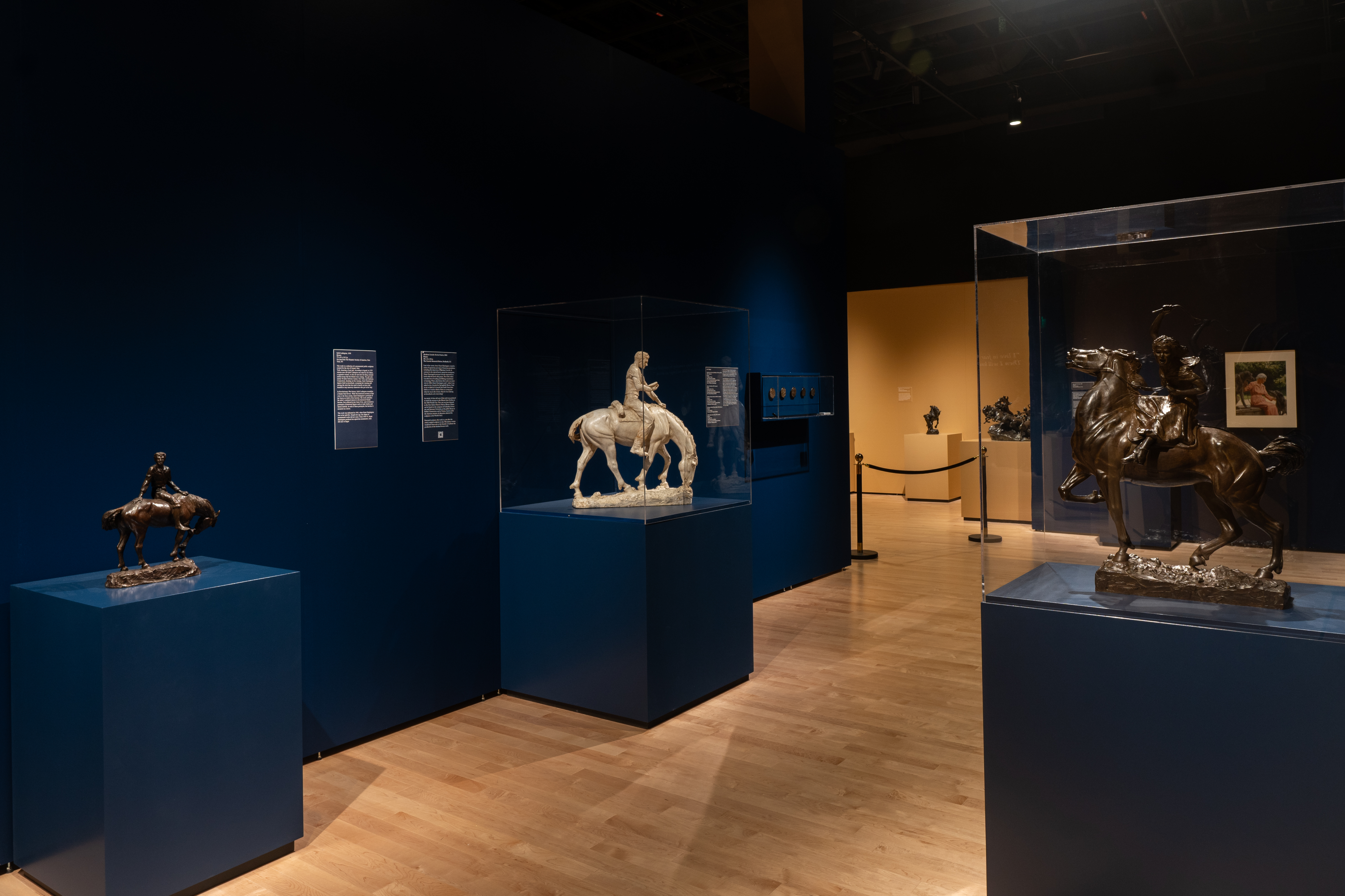 Three sculptures of men on horseback