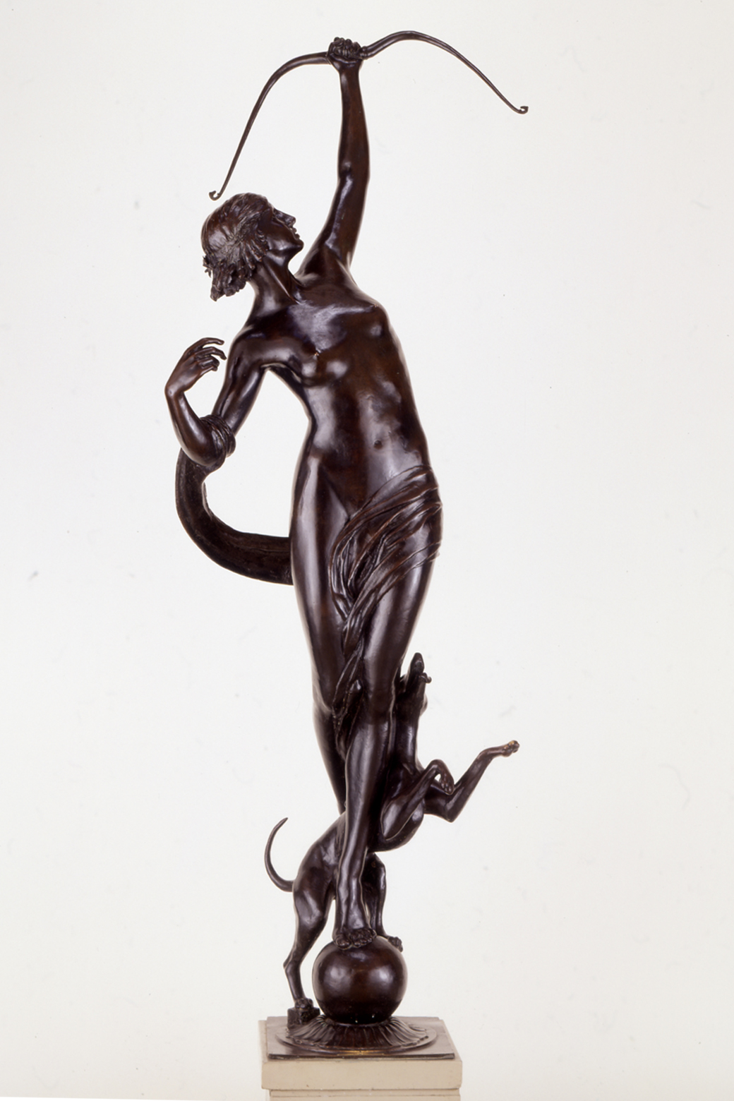 bronze sculpture of female form with bow