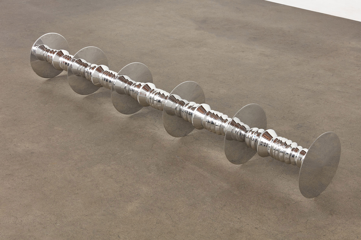 Image of a silver reflective cylinder resting on the ground 