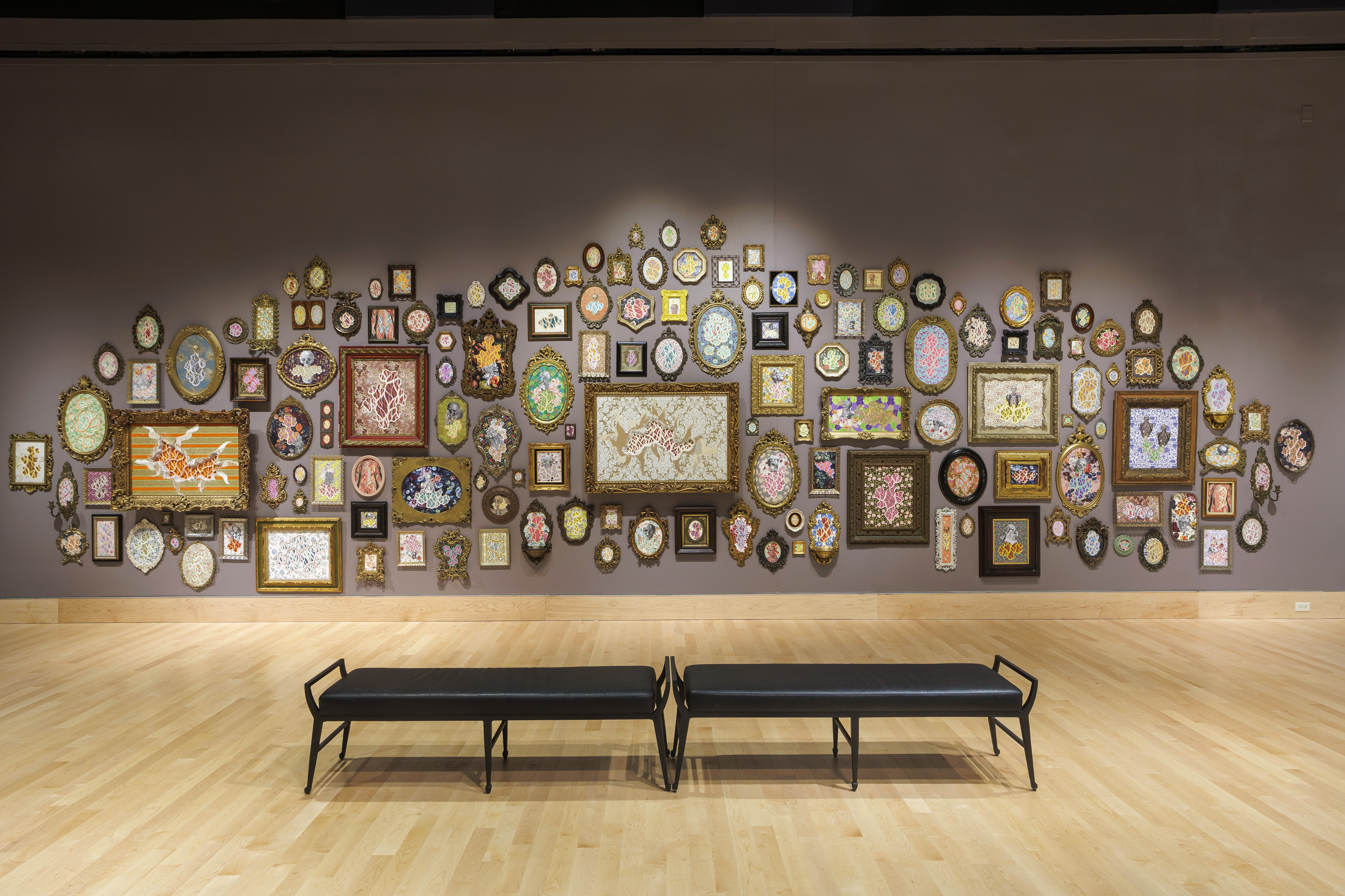 One large piece made up of many picture frames with works of art in them