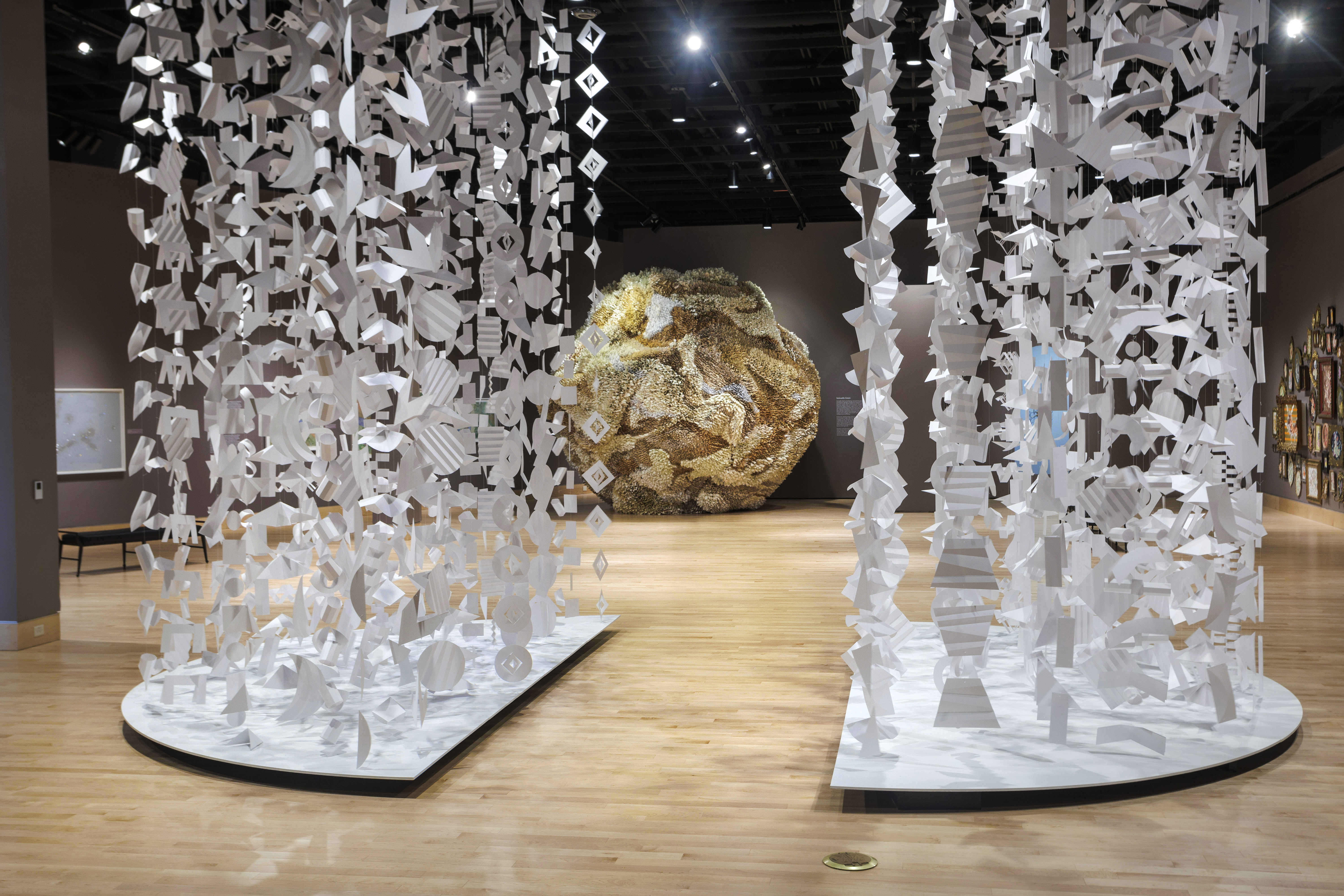 Two columns of paper and a gold ball in the distance