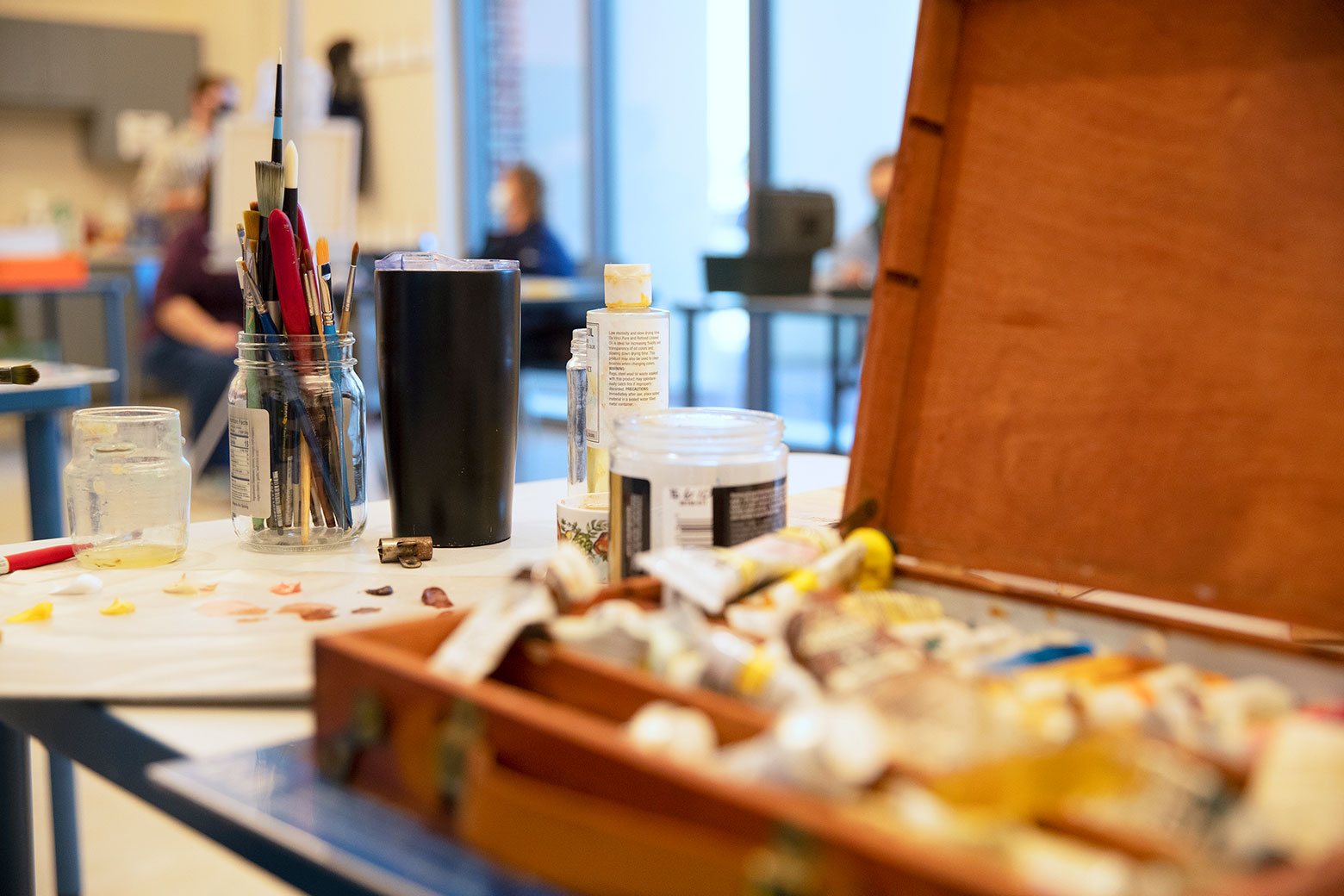 Closeup of paints and brushes in a Torggler art studio