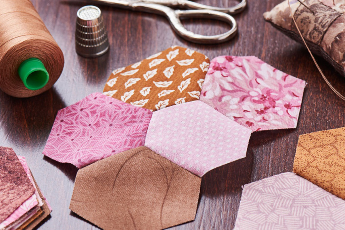 Hexagonal pieces of fabric being sewn together