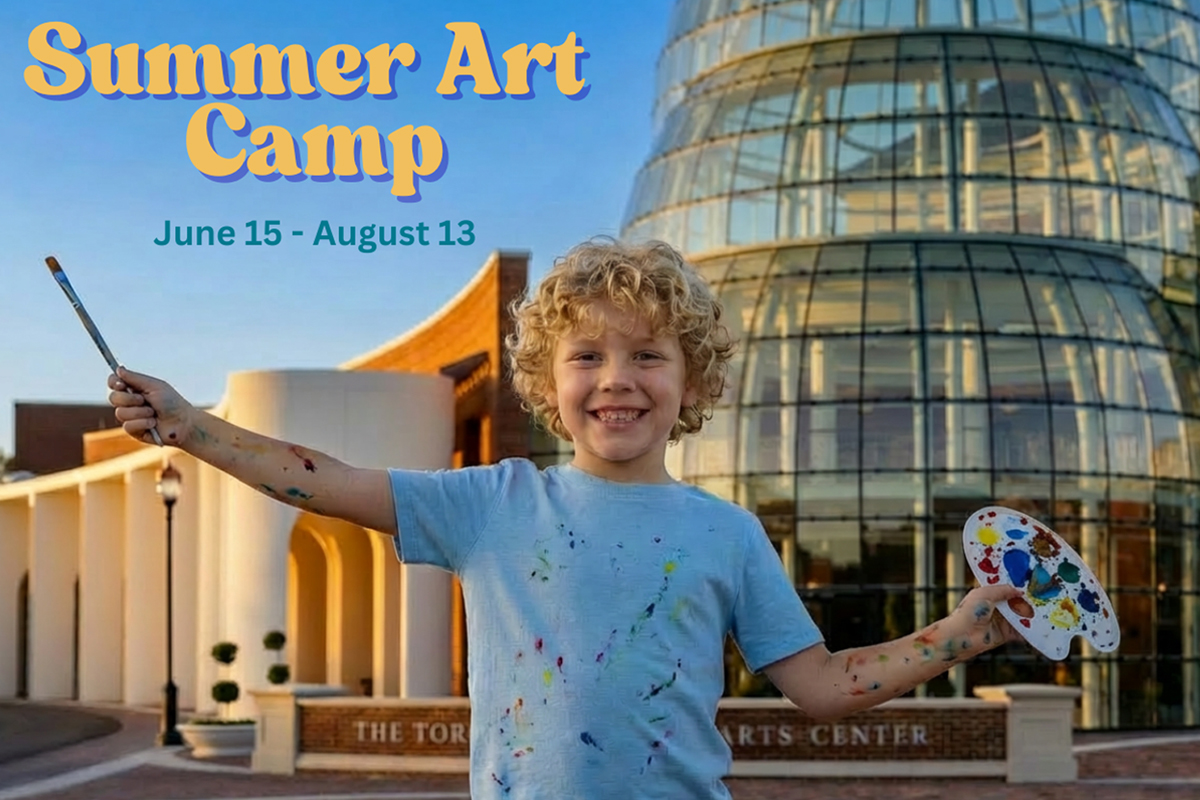 A teacher instructs students with colored pencils in the foreground