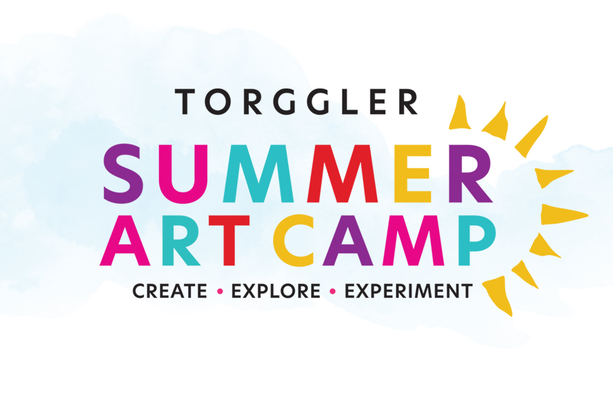 A teacher instructs students with colored pencils in the foreground